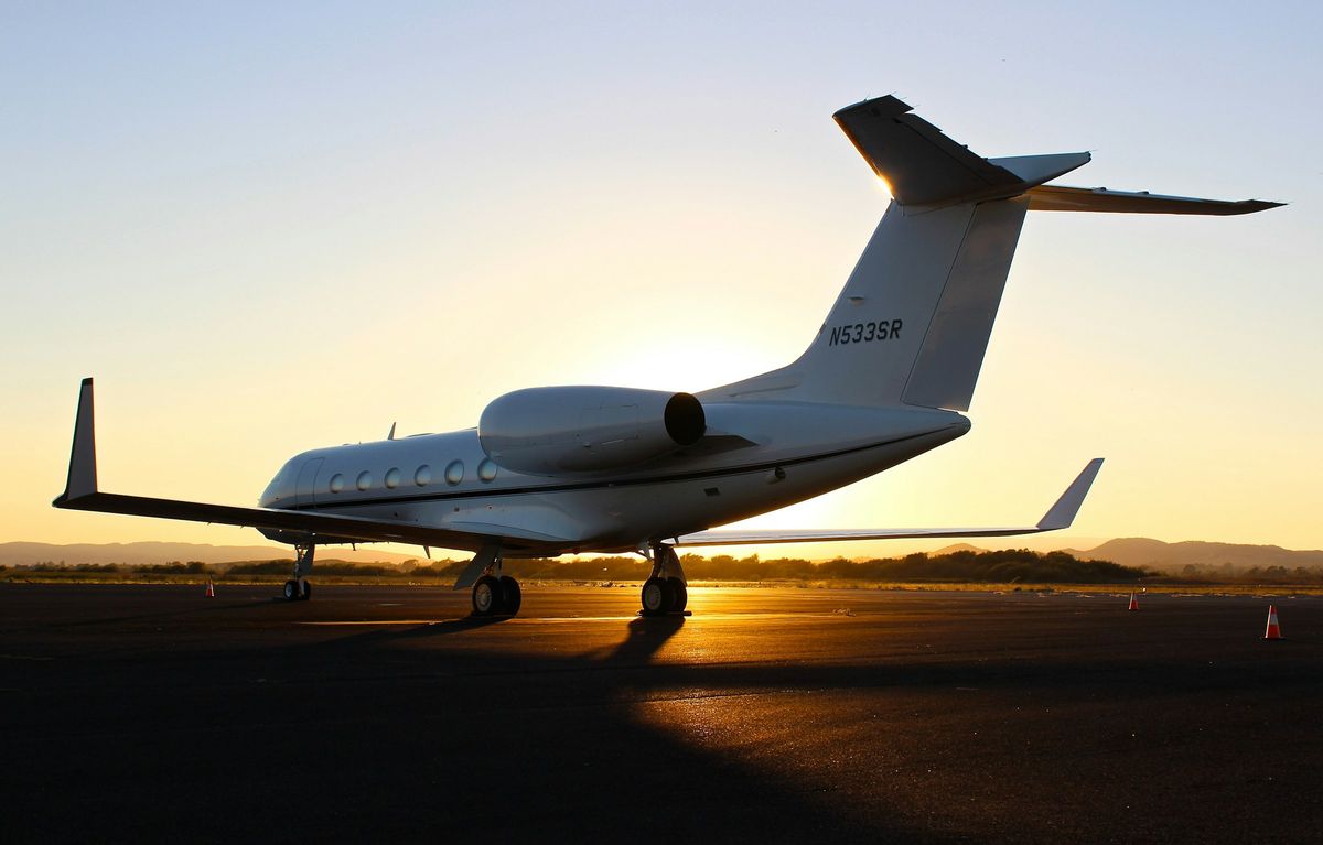 Private Jet mit veredelter Außenhaut auf dem Vorfeld bei Sonnenuntergang